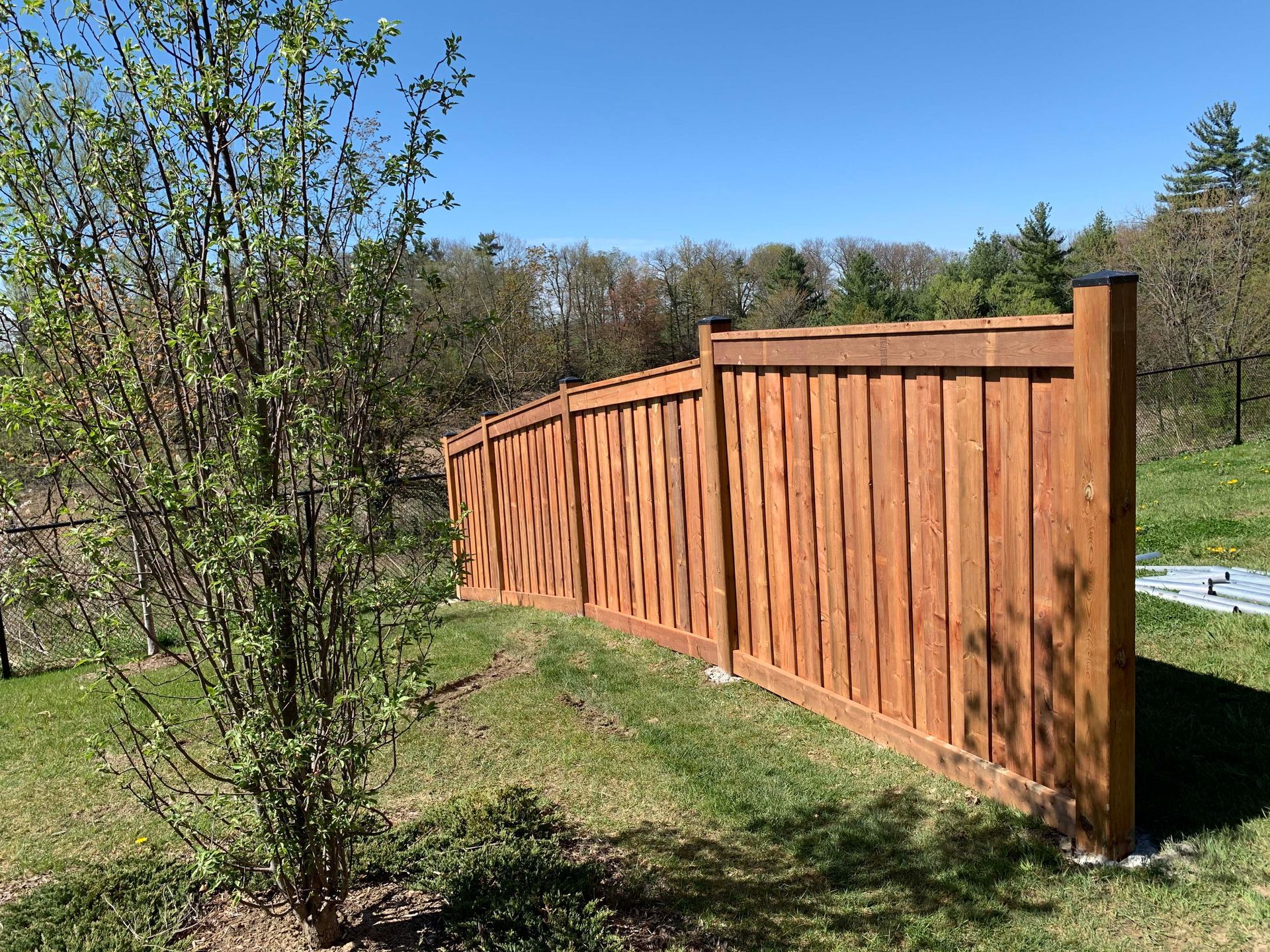 A wooden fence is sitting in the middle of a grassy field.