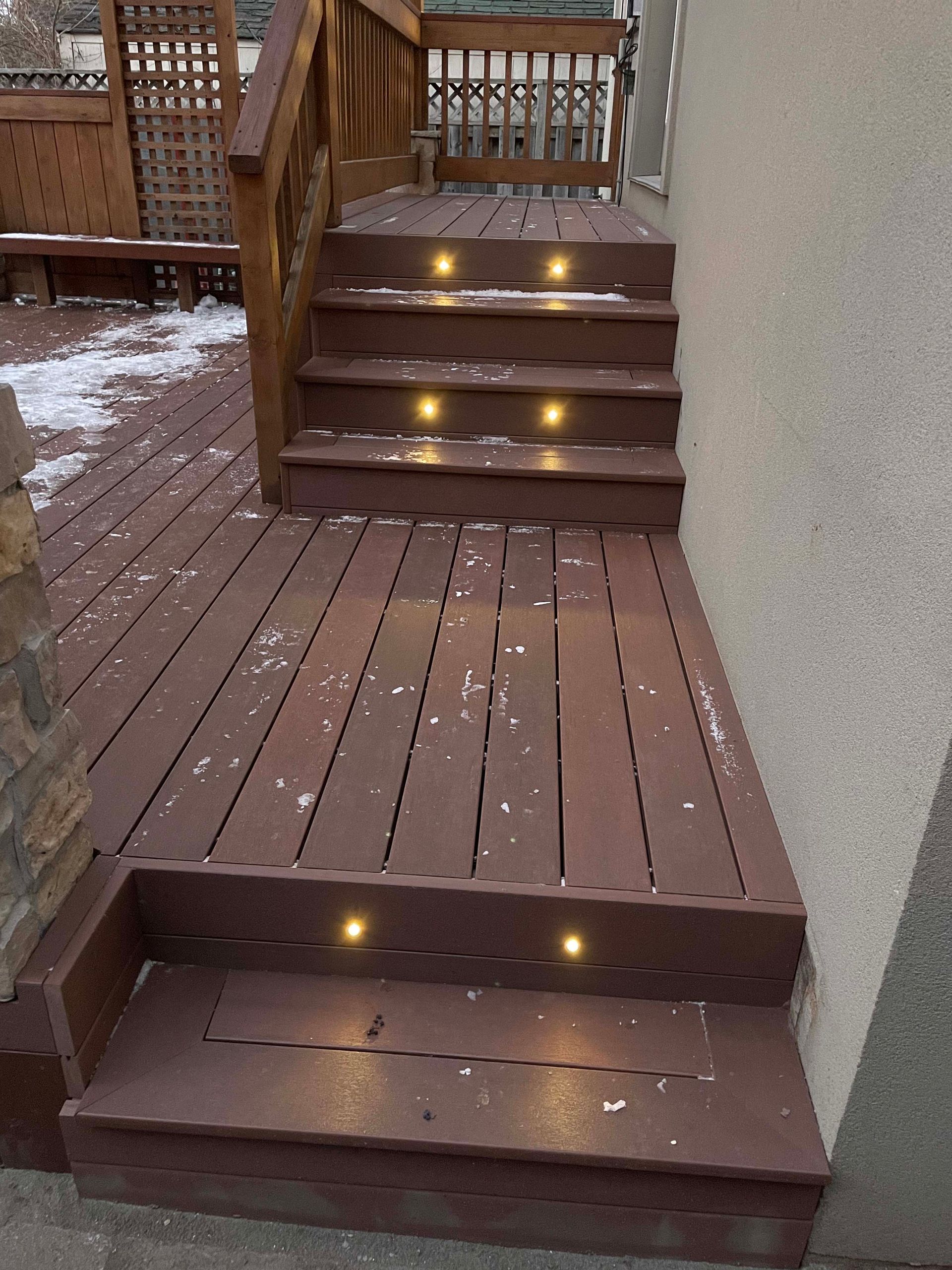 A wooden deck with stairs leading up to it