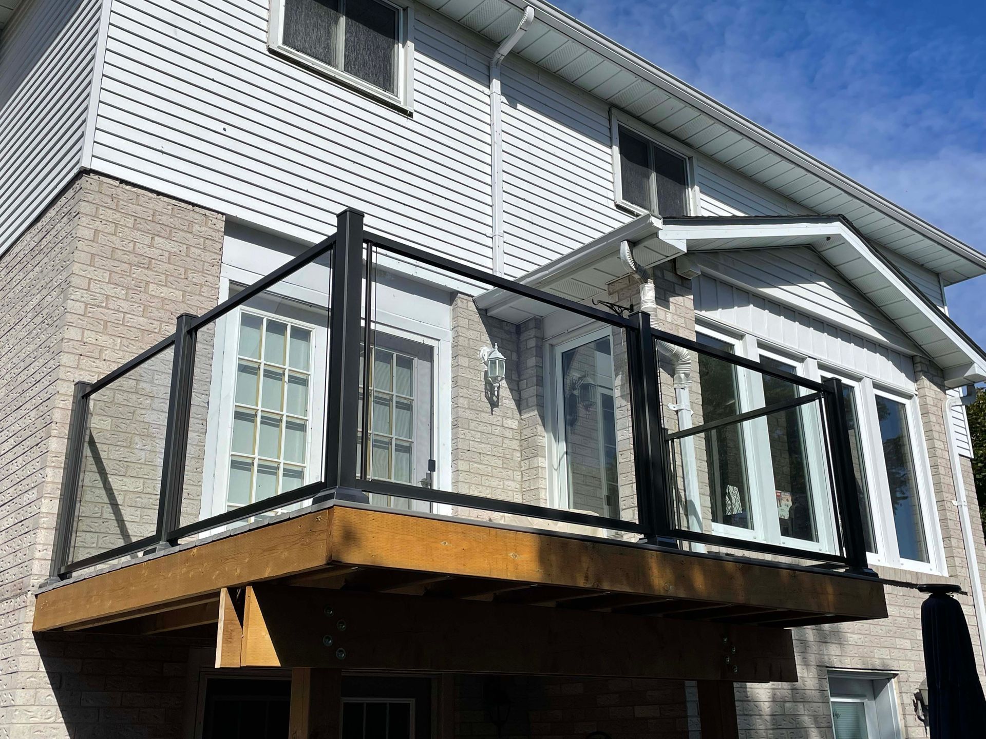 A house with a balcony and a glass railing