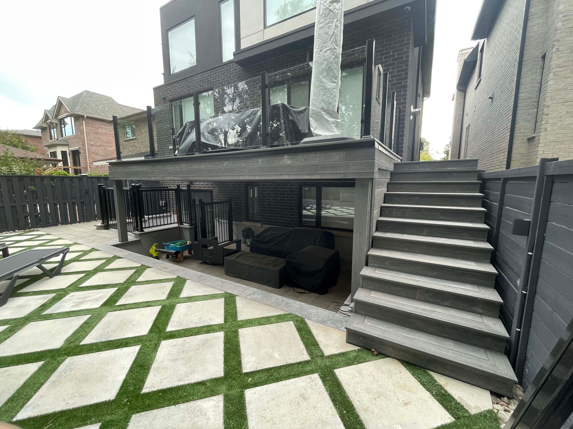 There are stairs leading up to the deck of a house.