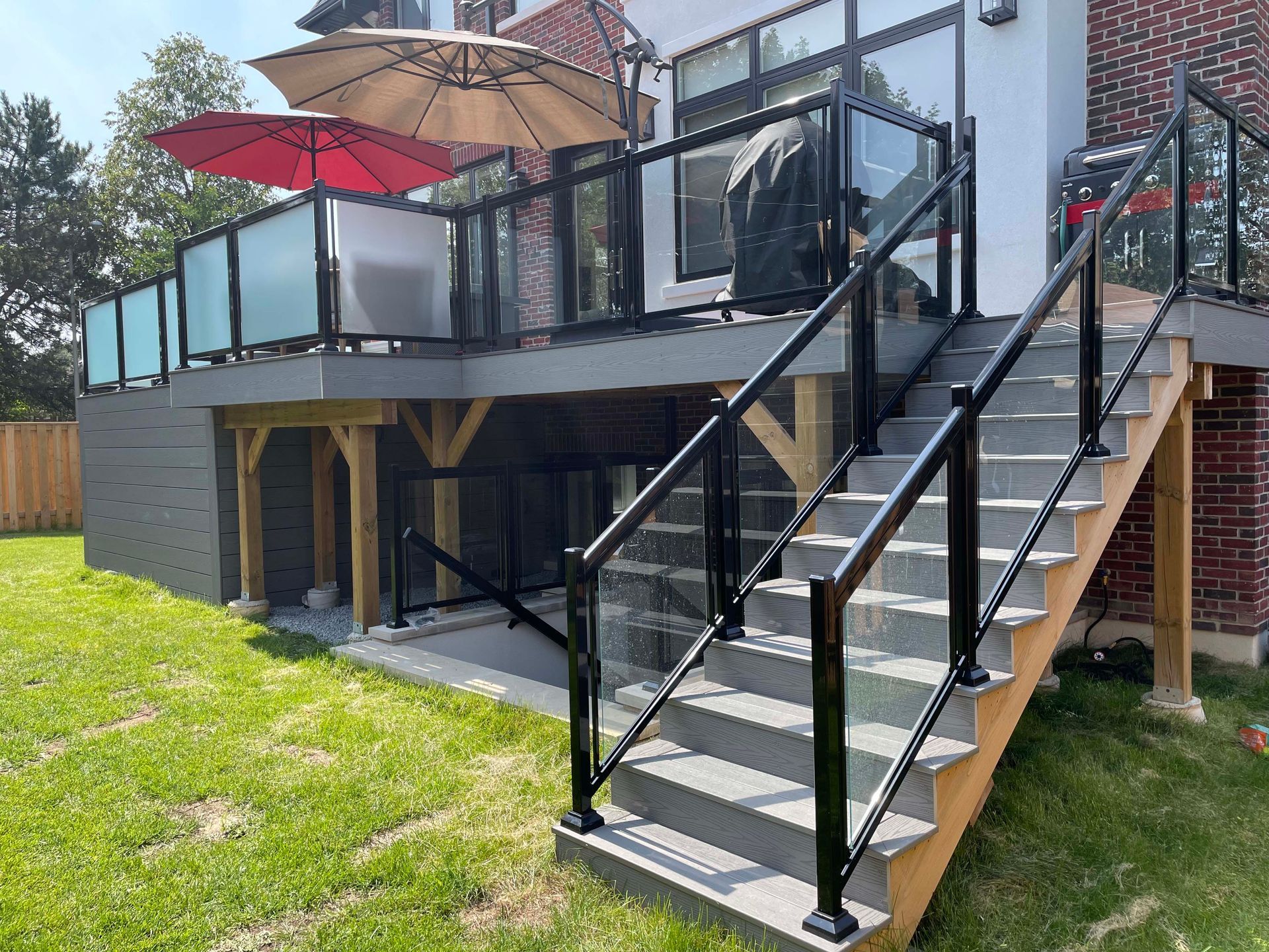 There are stairs leading up to a deck with umbrellas on it.