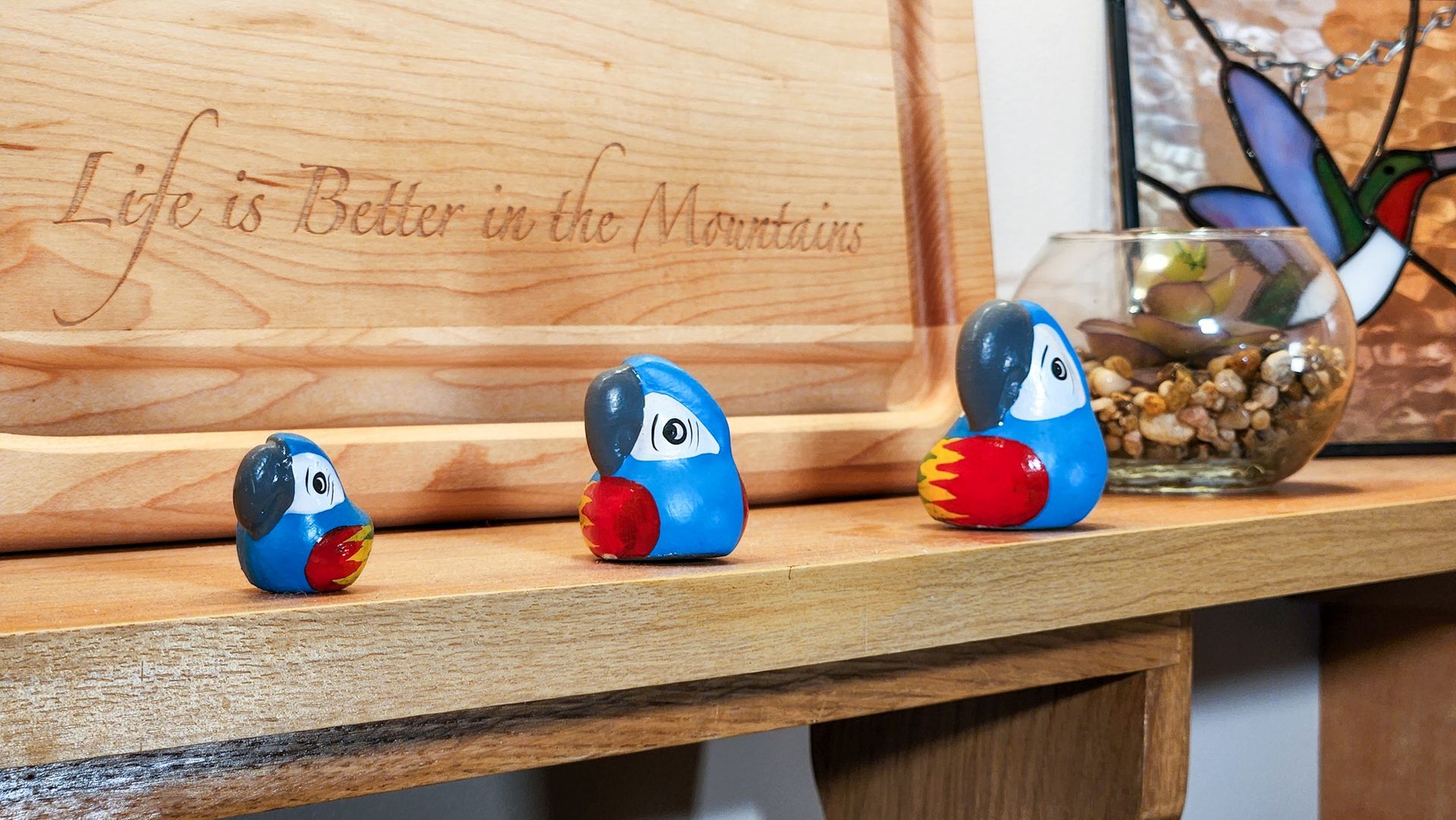 A wooden shelf with a sign that says life is better in the mountains