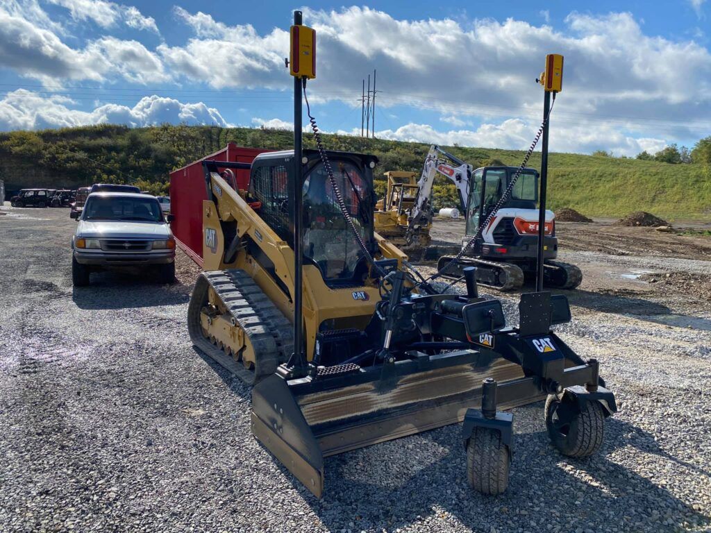A yellow bulldozer is parked in a gravel lot