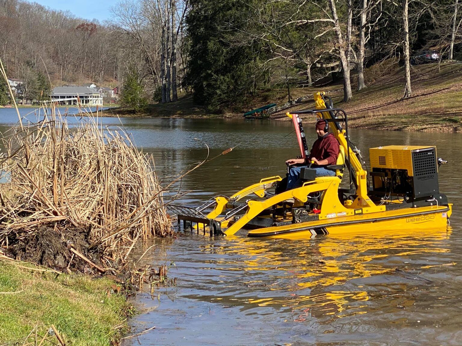 A man is driving a yellow boat in a lake