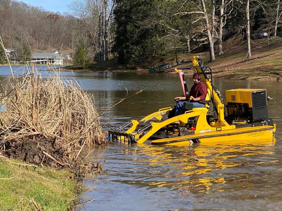 Bobcat skid loader removing debris during site preparation services.