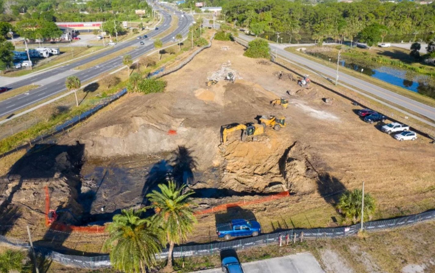 Grading and leveling a commercial site for construction preparation.