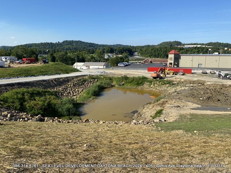 There is a large body of water in the middle of a field.