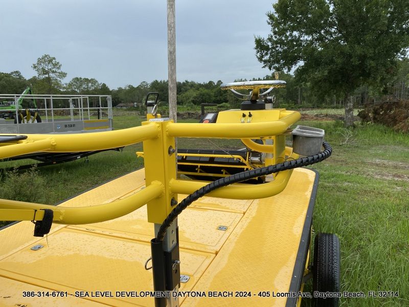 A yellow tractor is parked in a grassy field