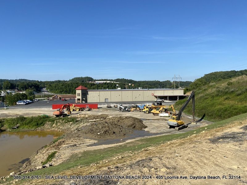 A large building with a lot of machinery in front of it