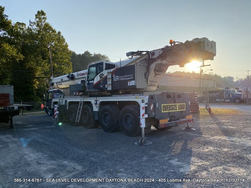 A large Material Transfer Placement crane is parked in a gravel lot ready for work in Daytona Beach, FL.