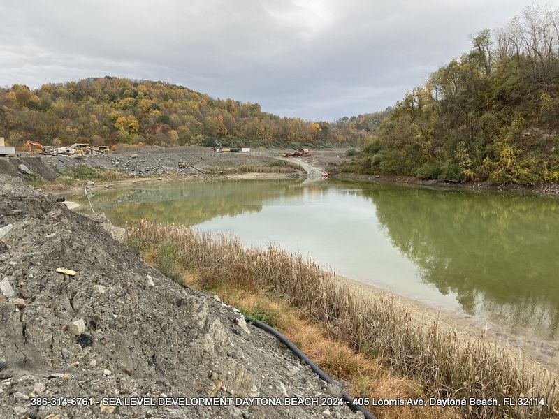 There is a large body of water in the middle of a forest.