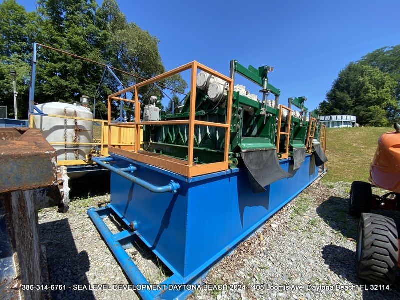 A blue and green machine with a railing on top of it