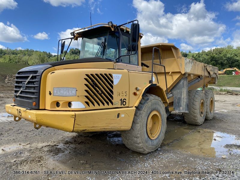 A yellow dump truck with the number 16 on it
