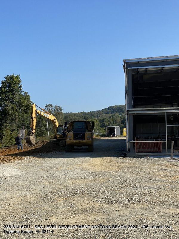 A construction site with a large building in the background