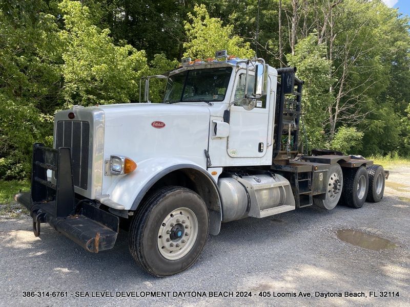 A white semi truck is parked in front of Sea Level Development, LLC.