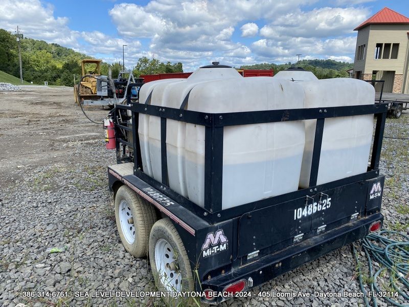 A trailer with a lot of portable water tanks on it