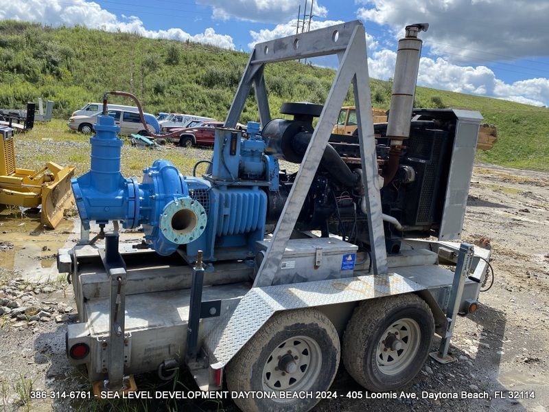A trailer with a large blue pump on it