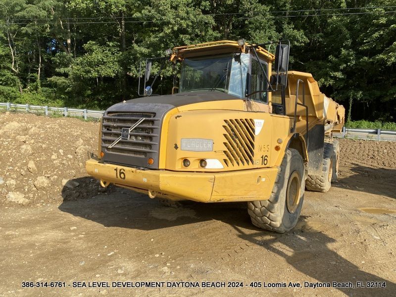 A yellow dump truck with the number 16 on it