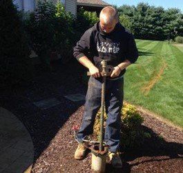 Man Holding Drilling Tool - Stow, OH - Anderson Drilling & Pump, Inc