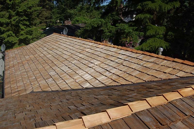 a wooden roof with a satellite dish on it