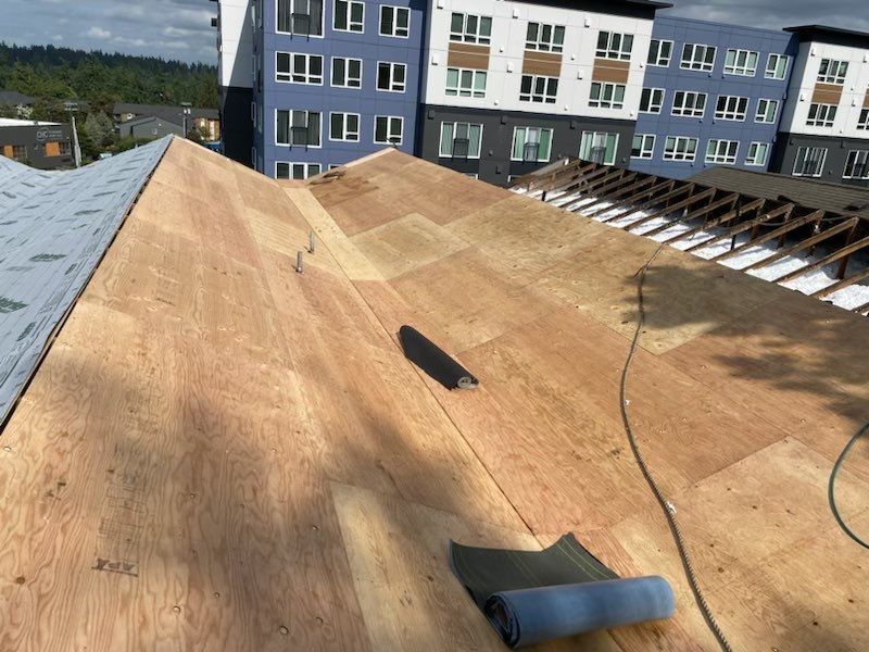 a roof that is being built with a building in the background