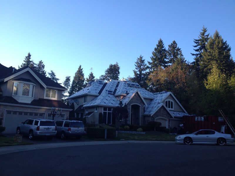 a white car is parked in front of a house
