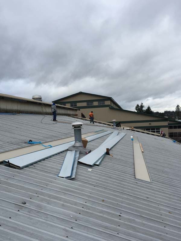 a man is standing on the roof of a building .