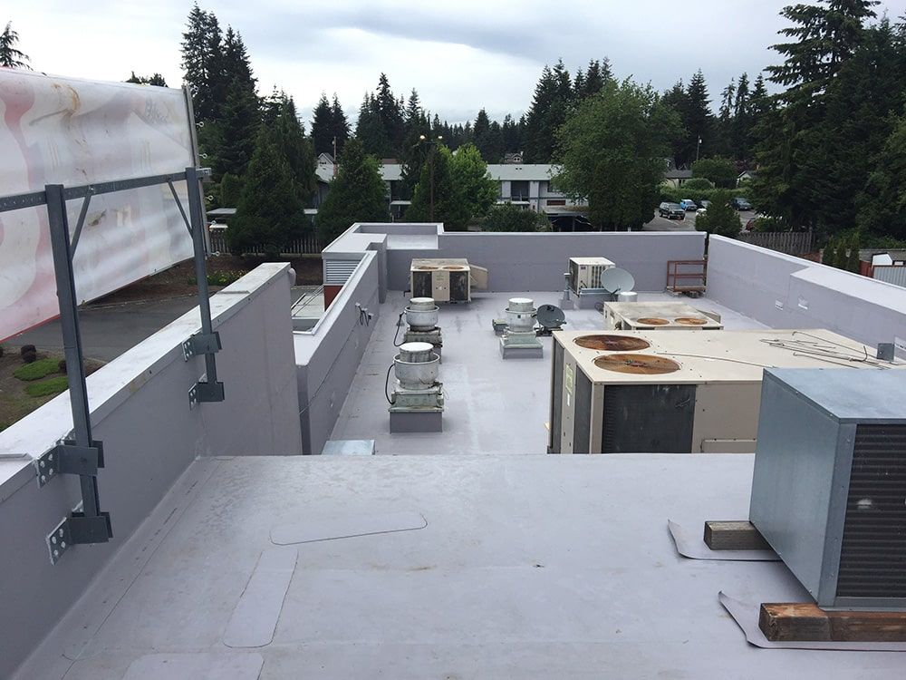 a rooftop with a lot of air conditioners on it
