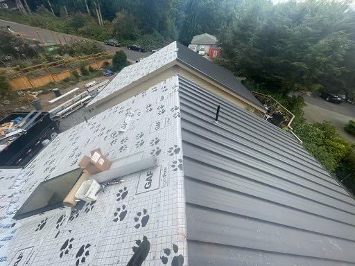 a metal roof is being installed on a house .