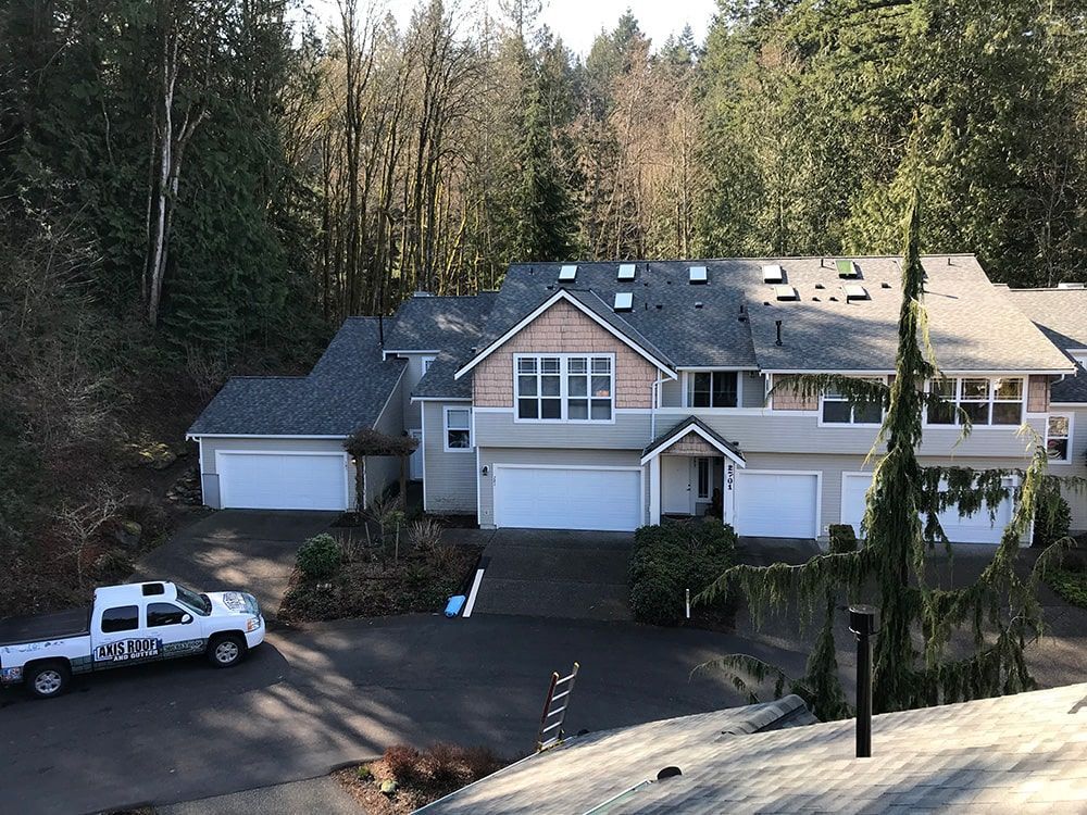 a white truck is parked in front of a large house