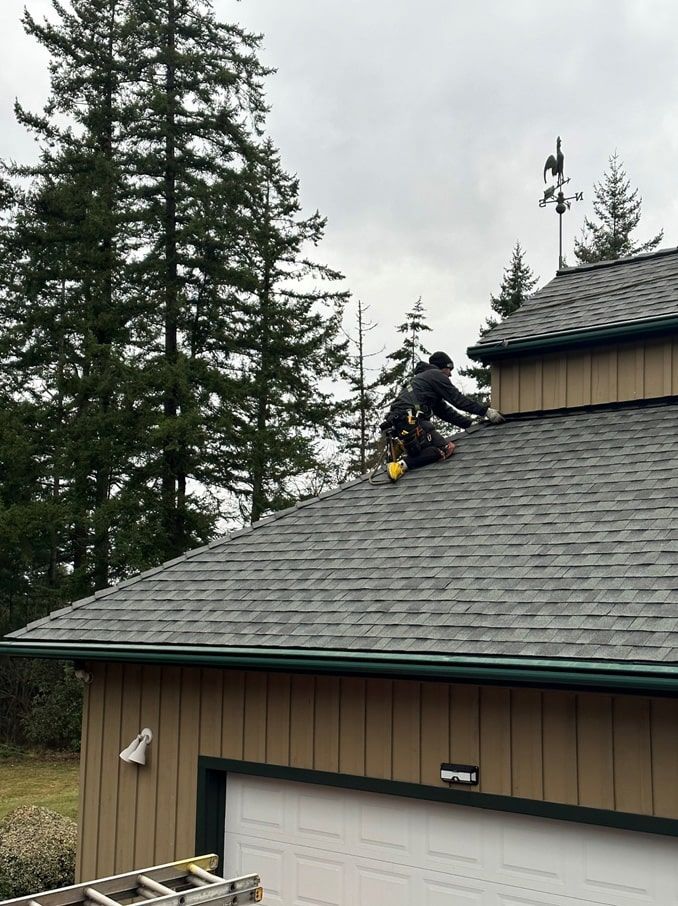 a man is working on the roof of a garage .