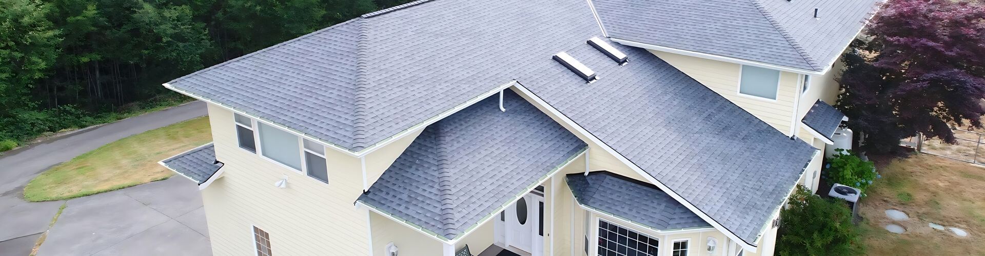 an aerial view of a large house with a gray roof .