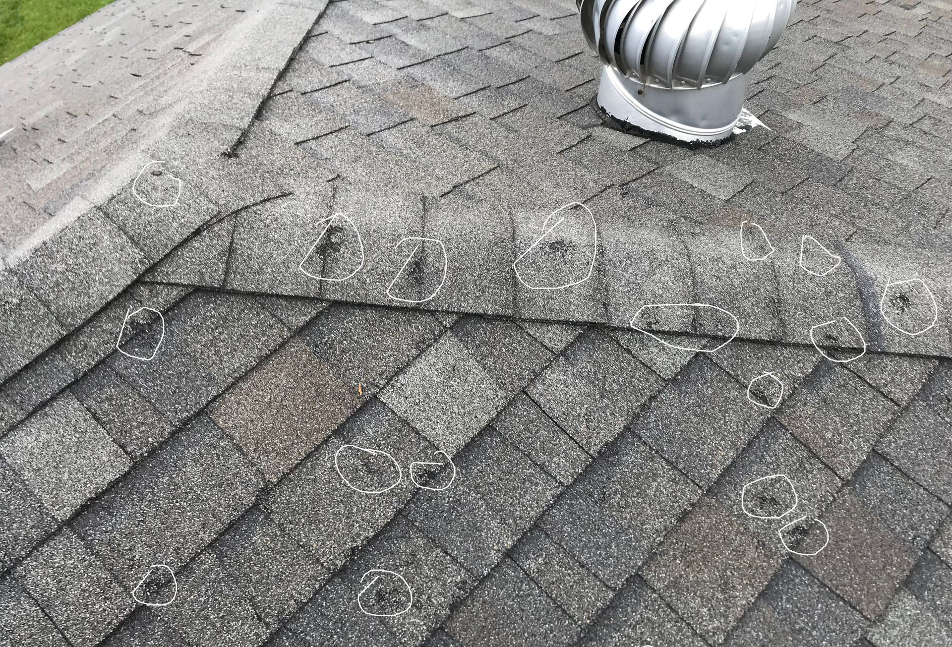 circles on a roof showing hail damage 