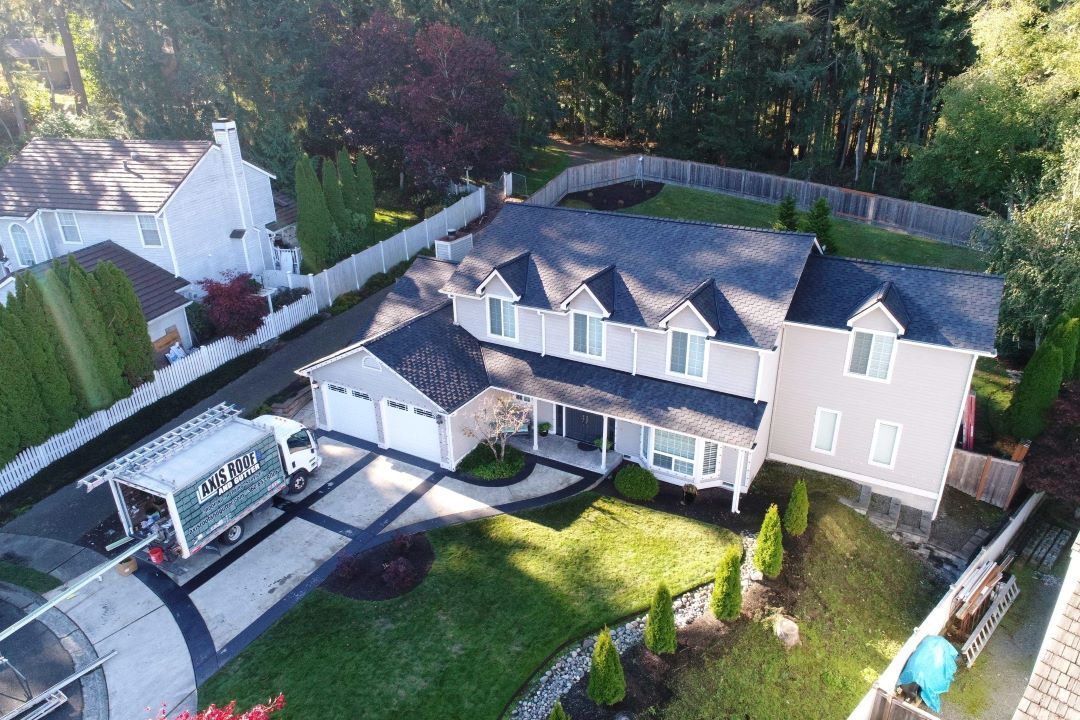 an aerial view of a large house with a truck parked in front of it .