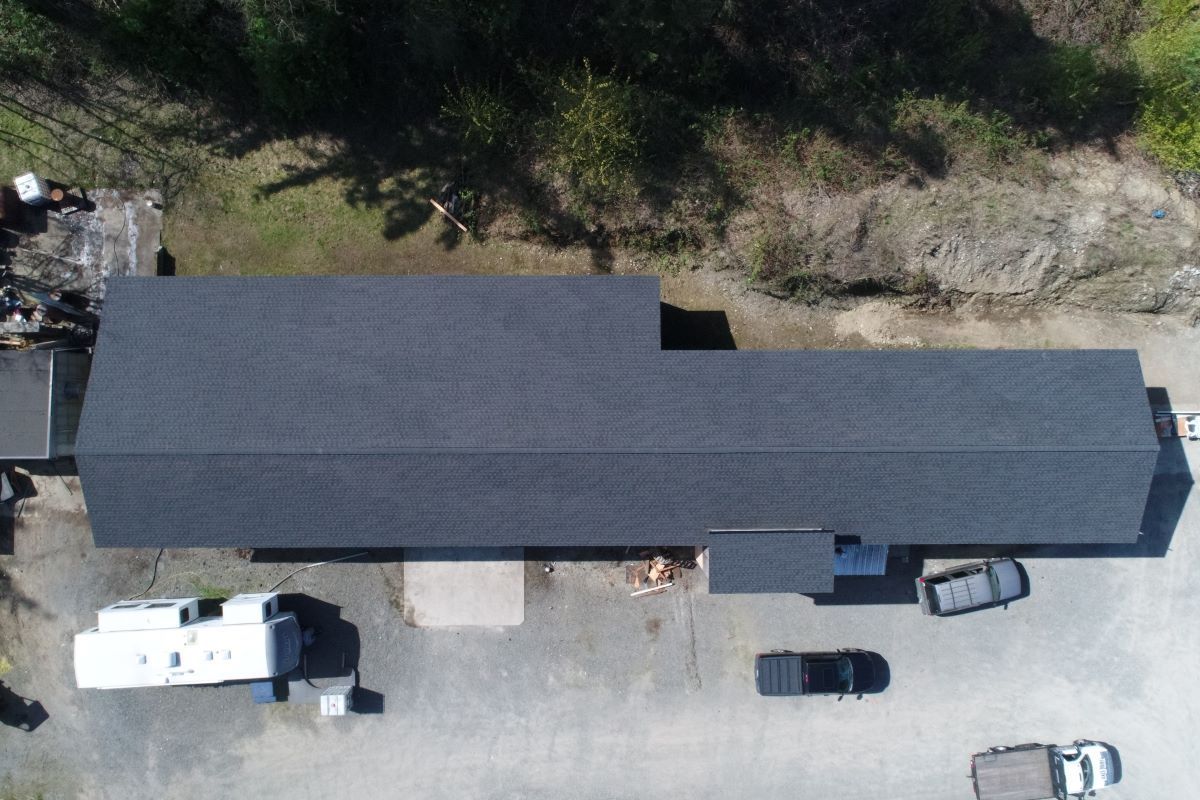 an aerial view of a building with a black roof