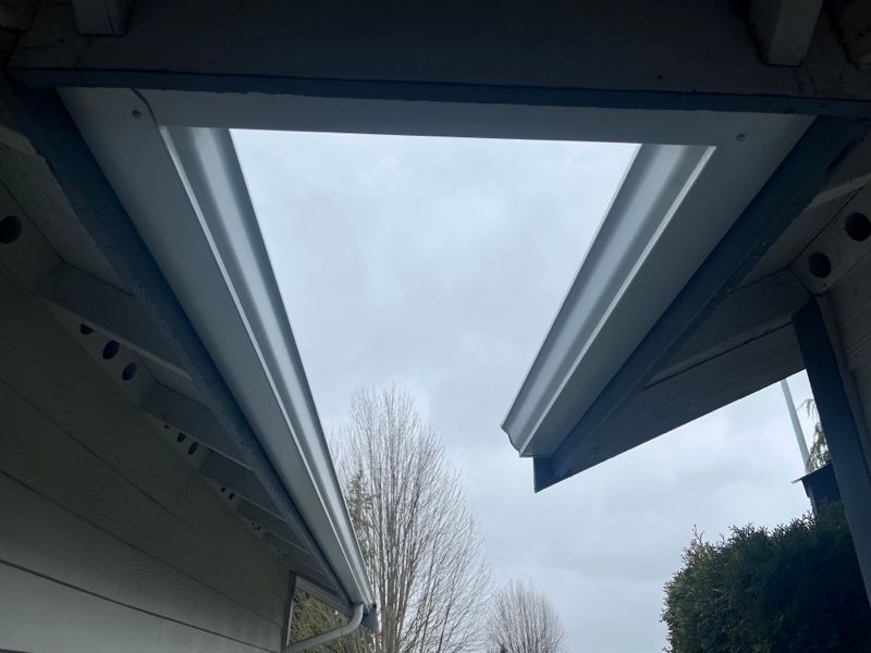the skylight is open and looking out to the sky .