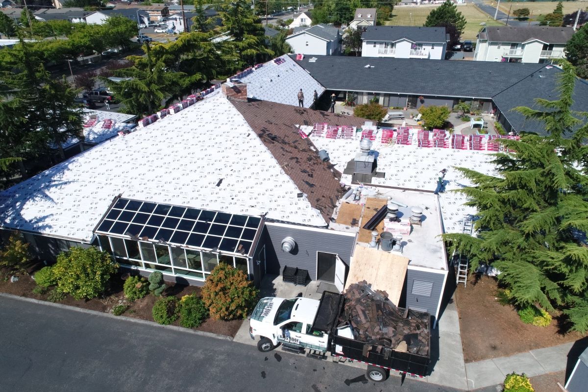 an aerial view of a building under construction with a truck parked in front of it .