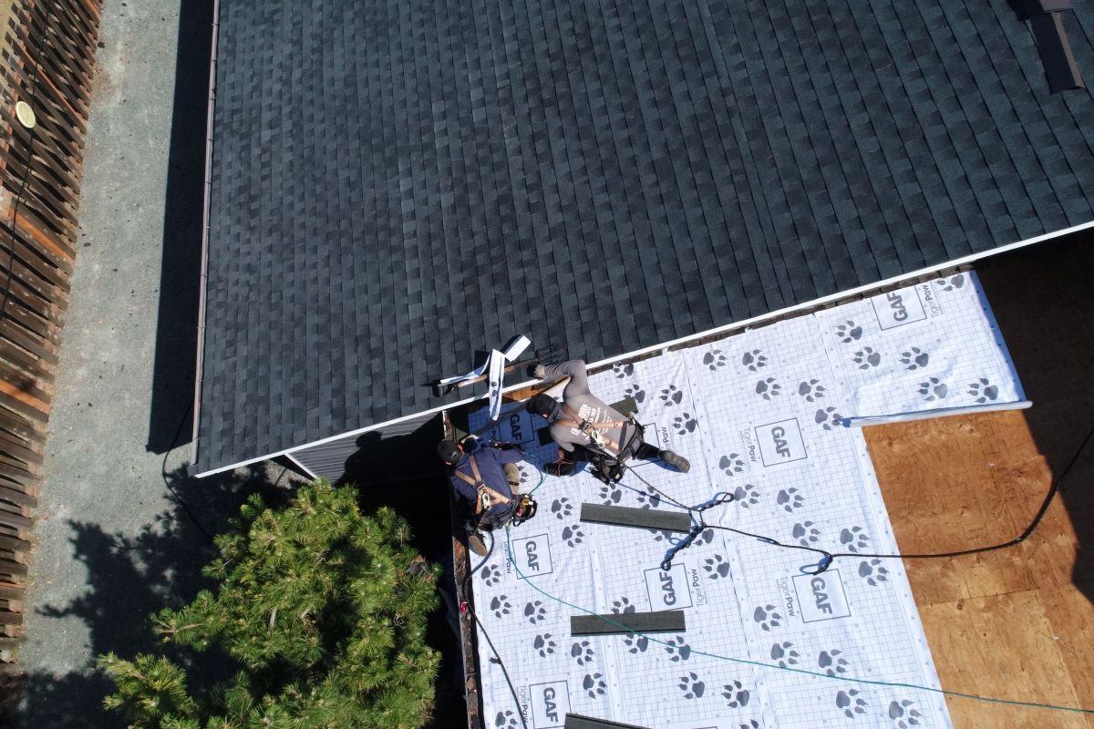 an aerial view of a roof being installed on a house .