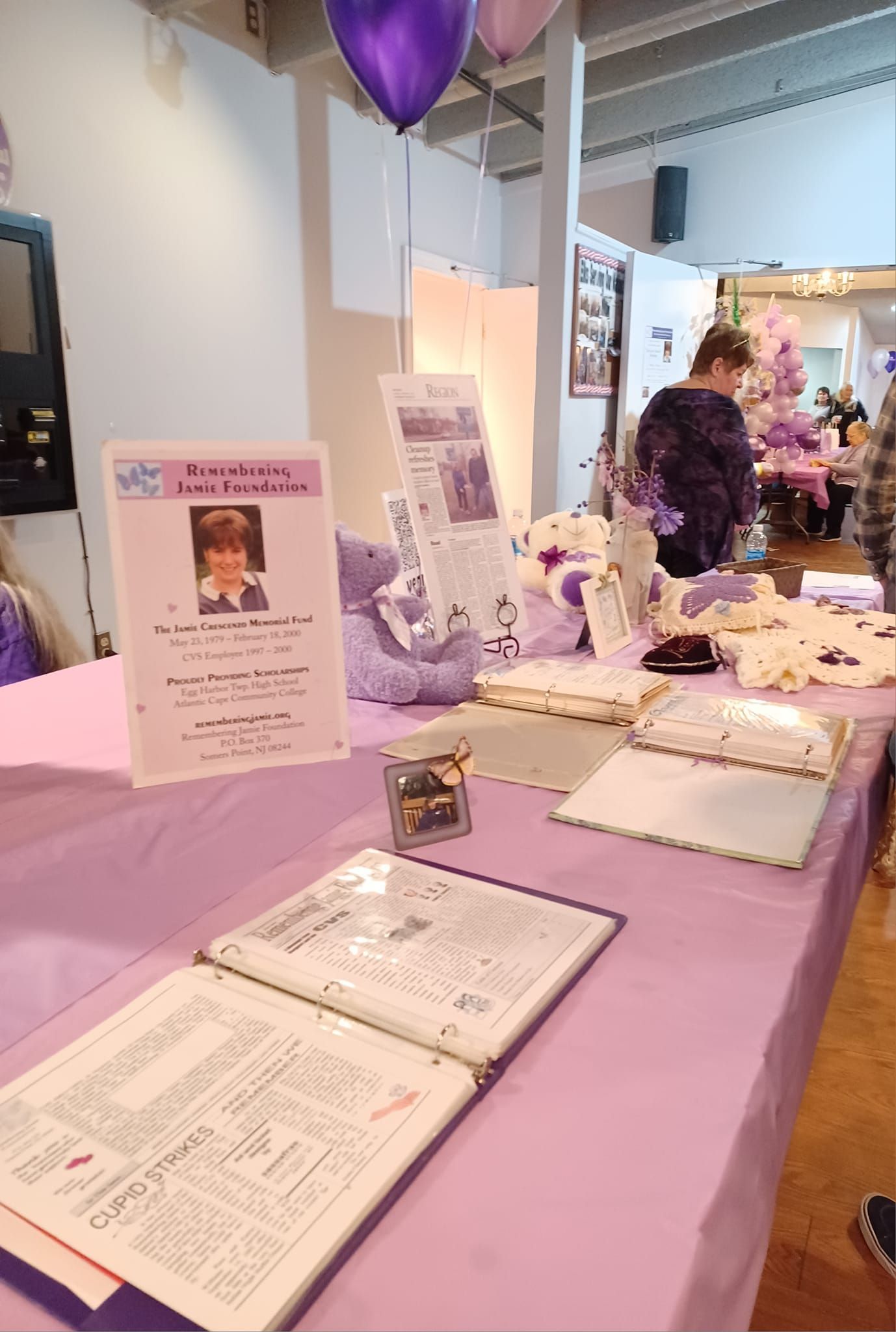 a purple table with a sign that says remembering a loved one