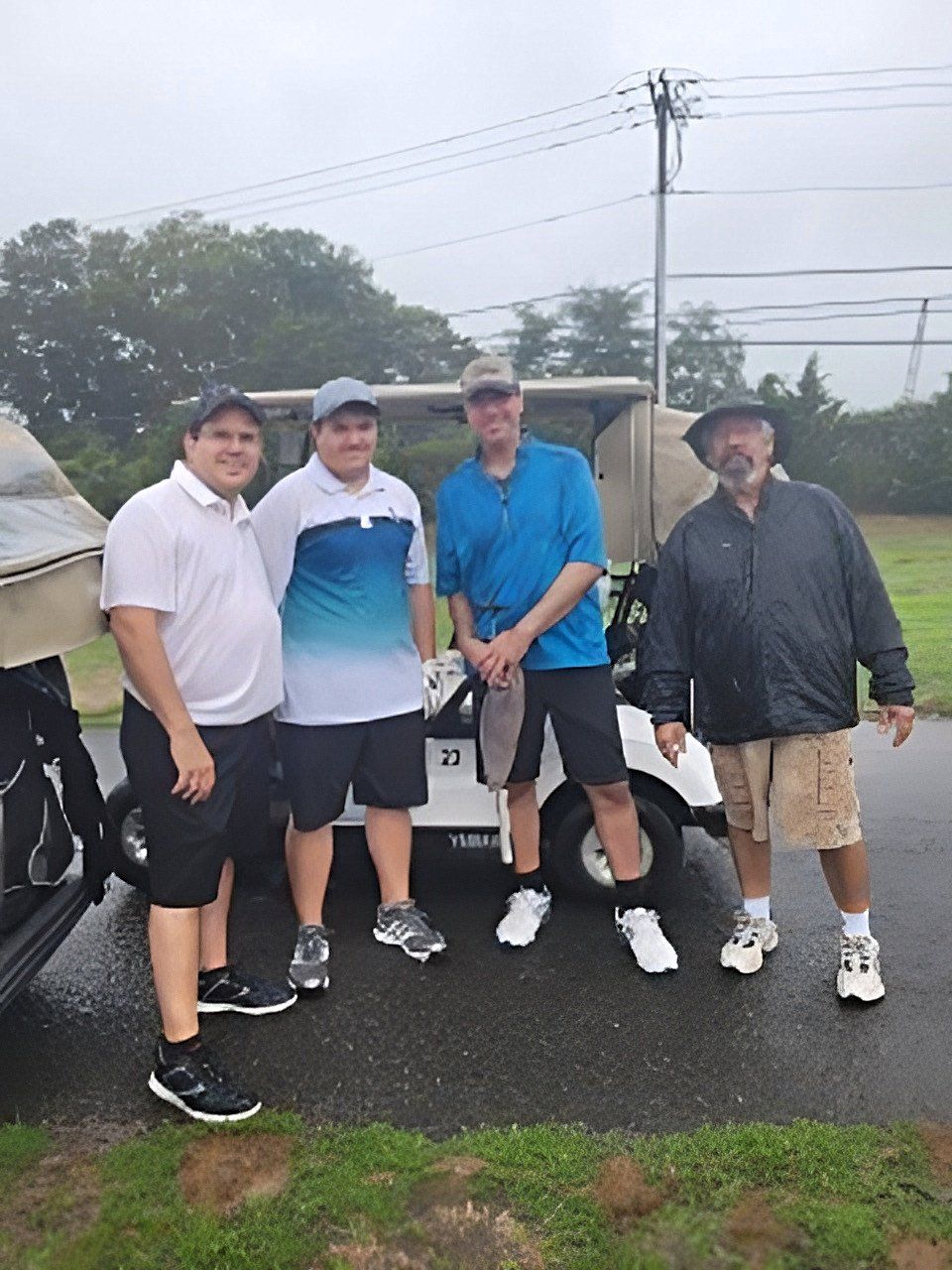 a group of men standing in front of a golf cart