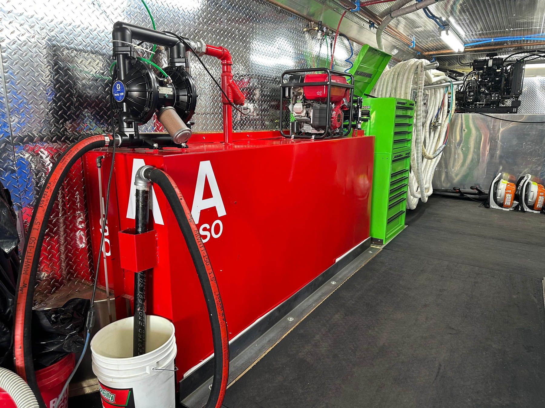 Inside a red, emergency vehicle is a water tank and pump system for firefighting.