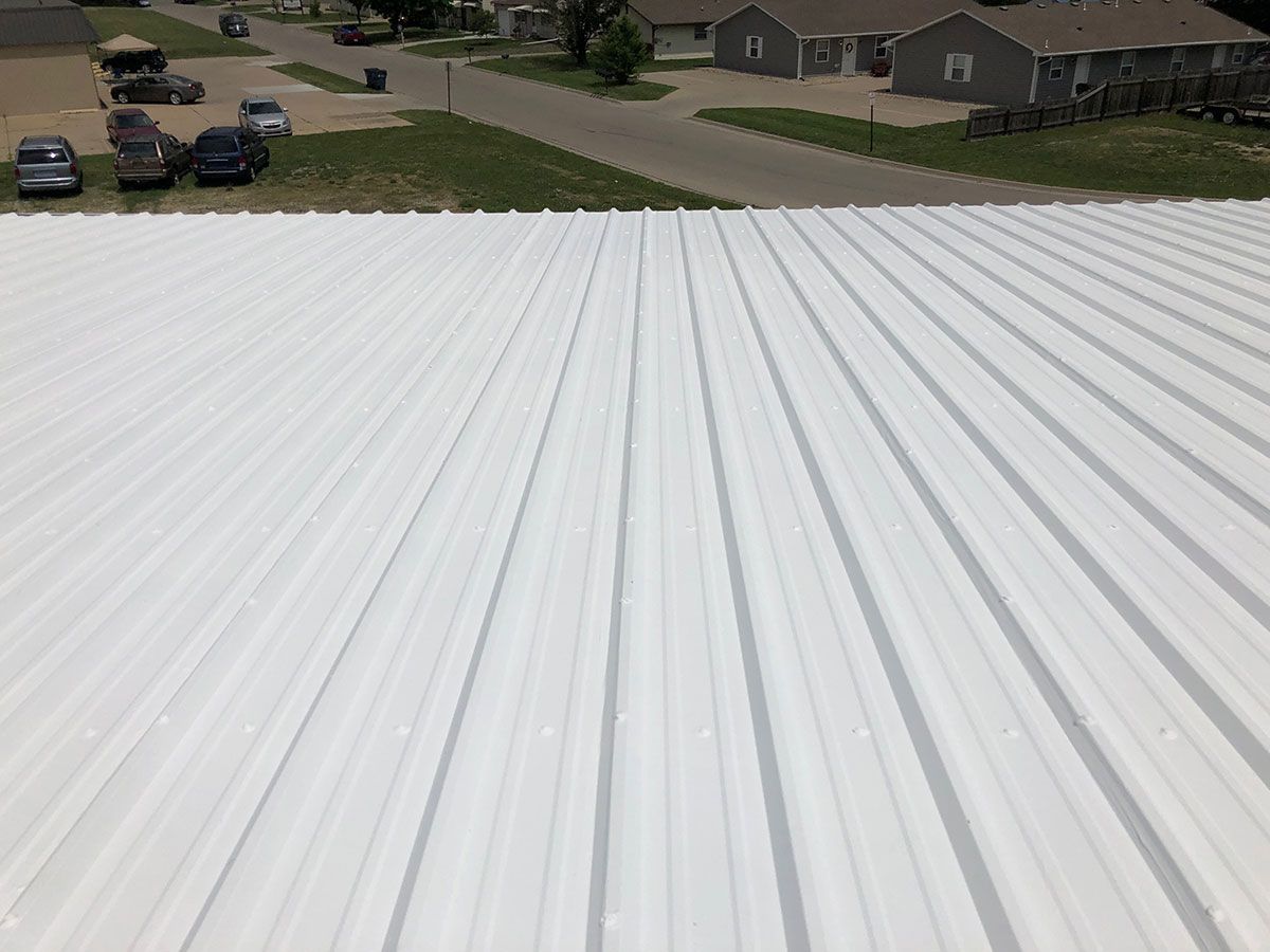 White corrugated metal roof, overlooking a residential street.