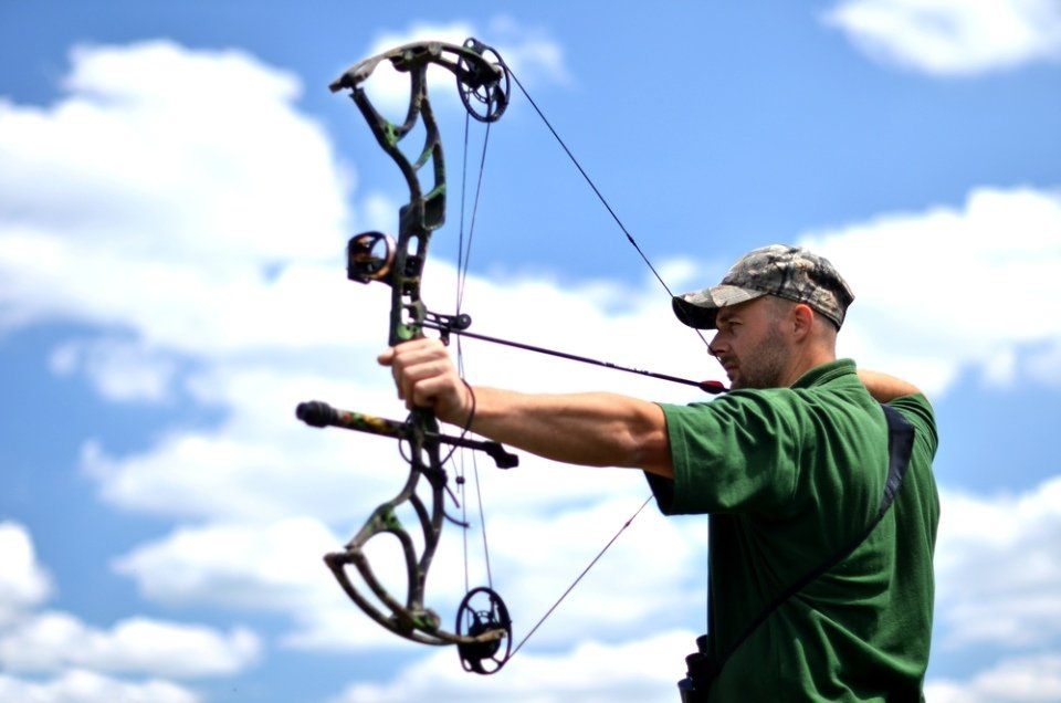 man practicing archery