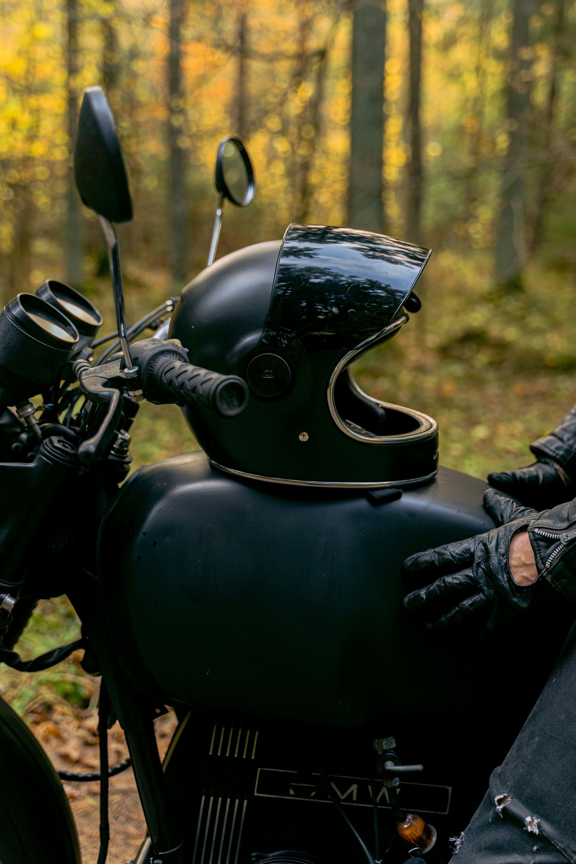 Dashboard view from a car driving at night; speedometer at 15 mph. In the background, a lit gas station.
