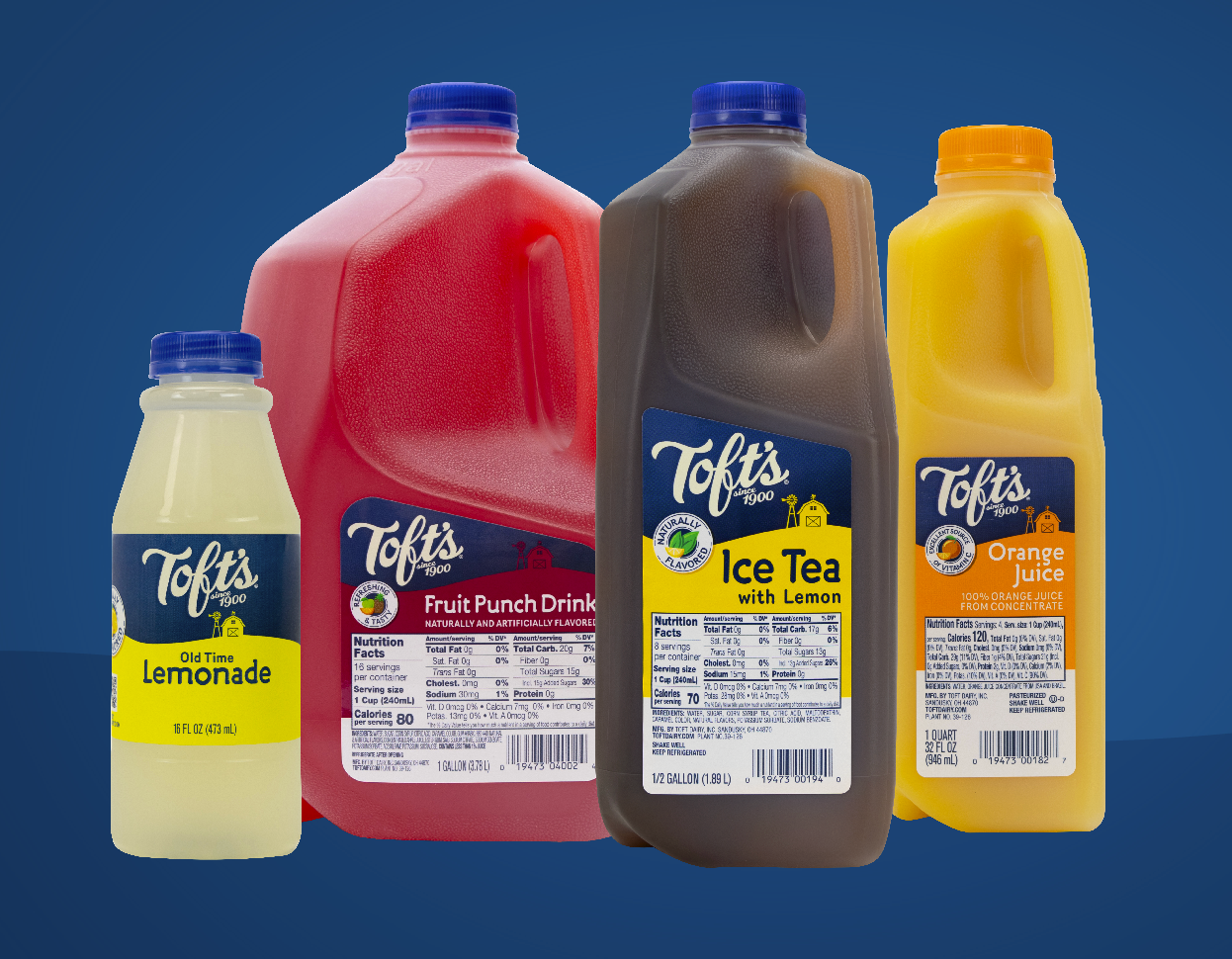 Four bottles of Toft's juice drinks are sitting next to each other on a blue background.