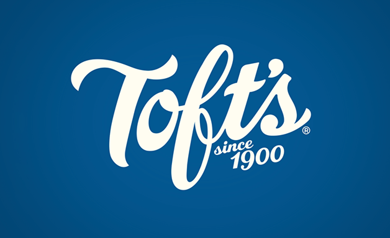 The logo for toft 's since 1900 is on a blue background