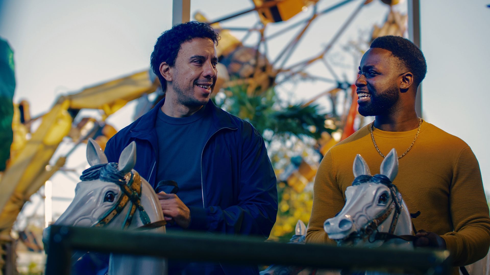 Zwei Männer sitzen in einem Karussell in einem Vergnügungspark