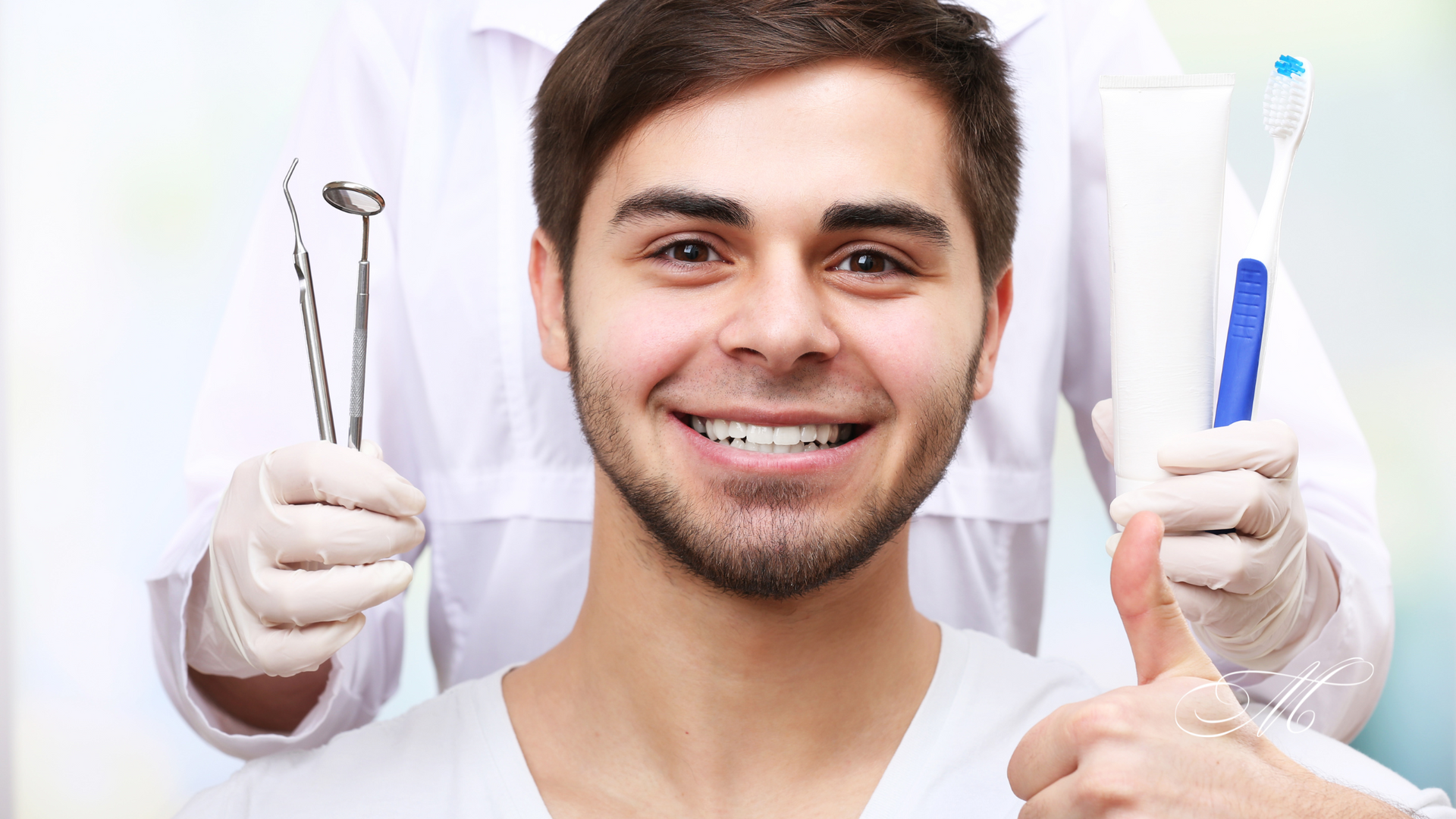 A man is giving a thumbs up while sitting in a dental chair.