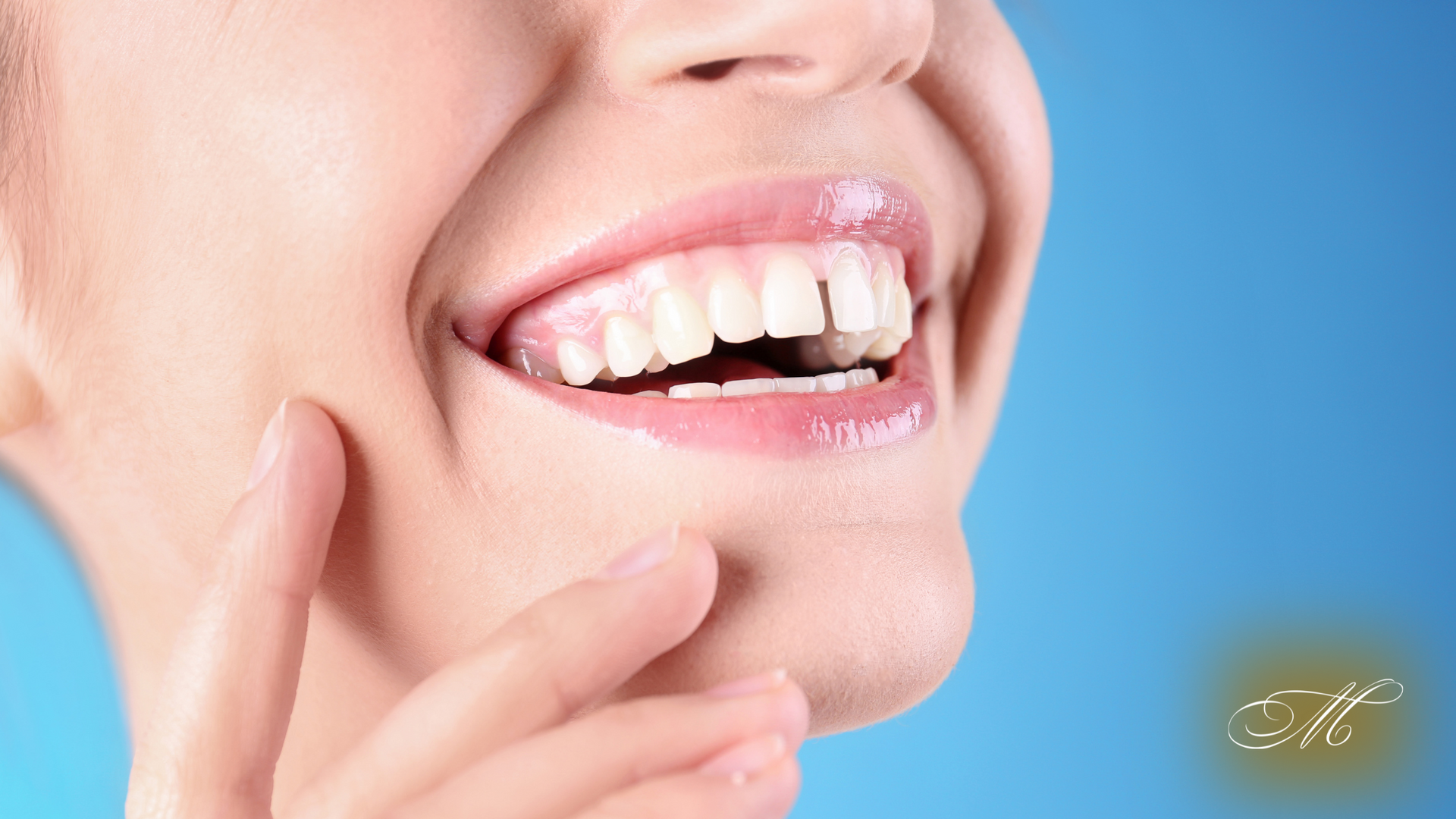 A close up of a woman 's mouth with her hand on her chin.