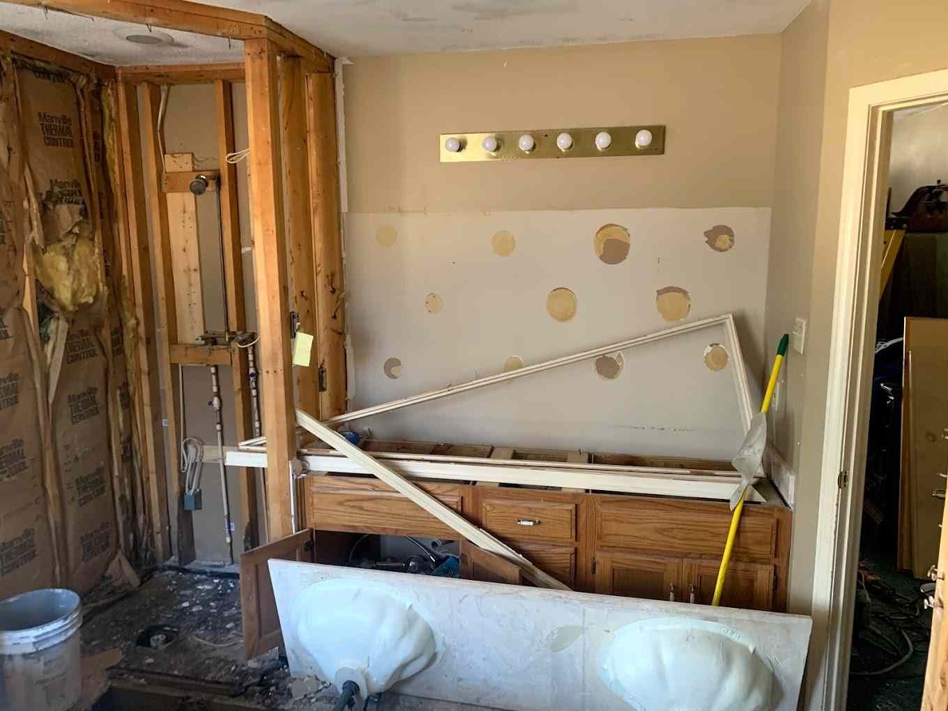 A bathroom under construction with a sink and cabinets.